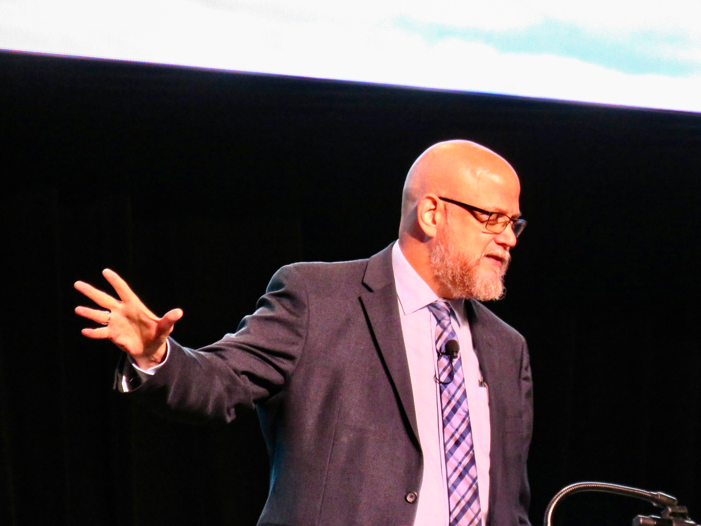 Greg Willits speaking on stage